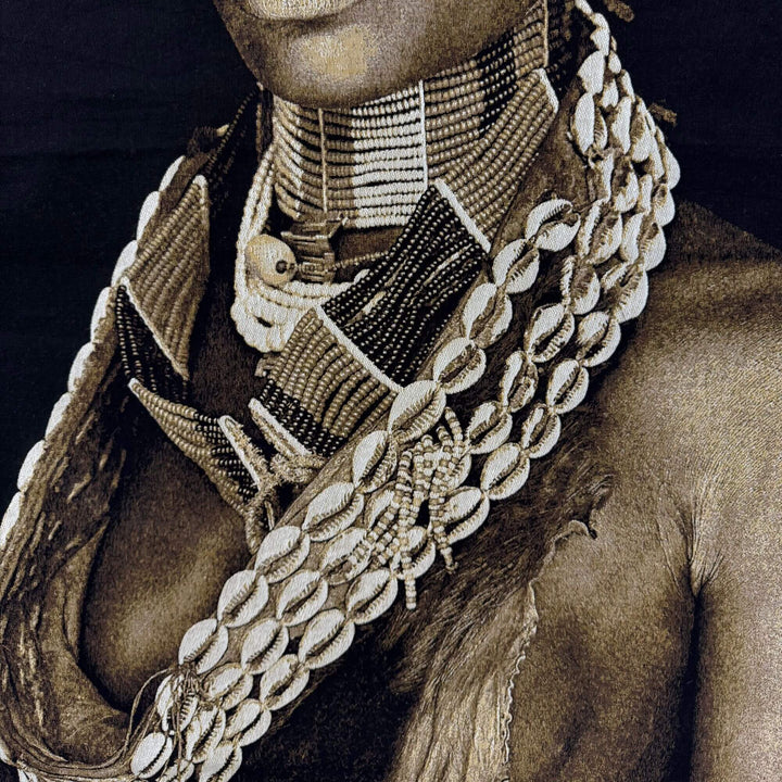 Close-up detail of the tapestry showing textured fabric and intricate necklace design.