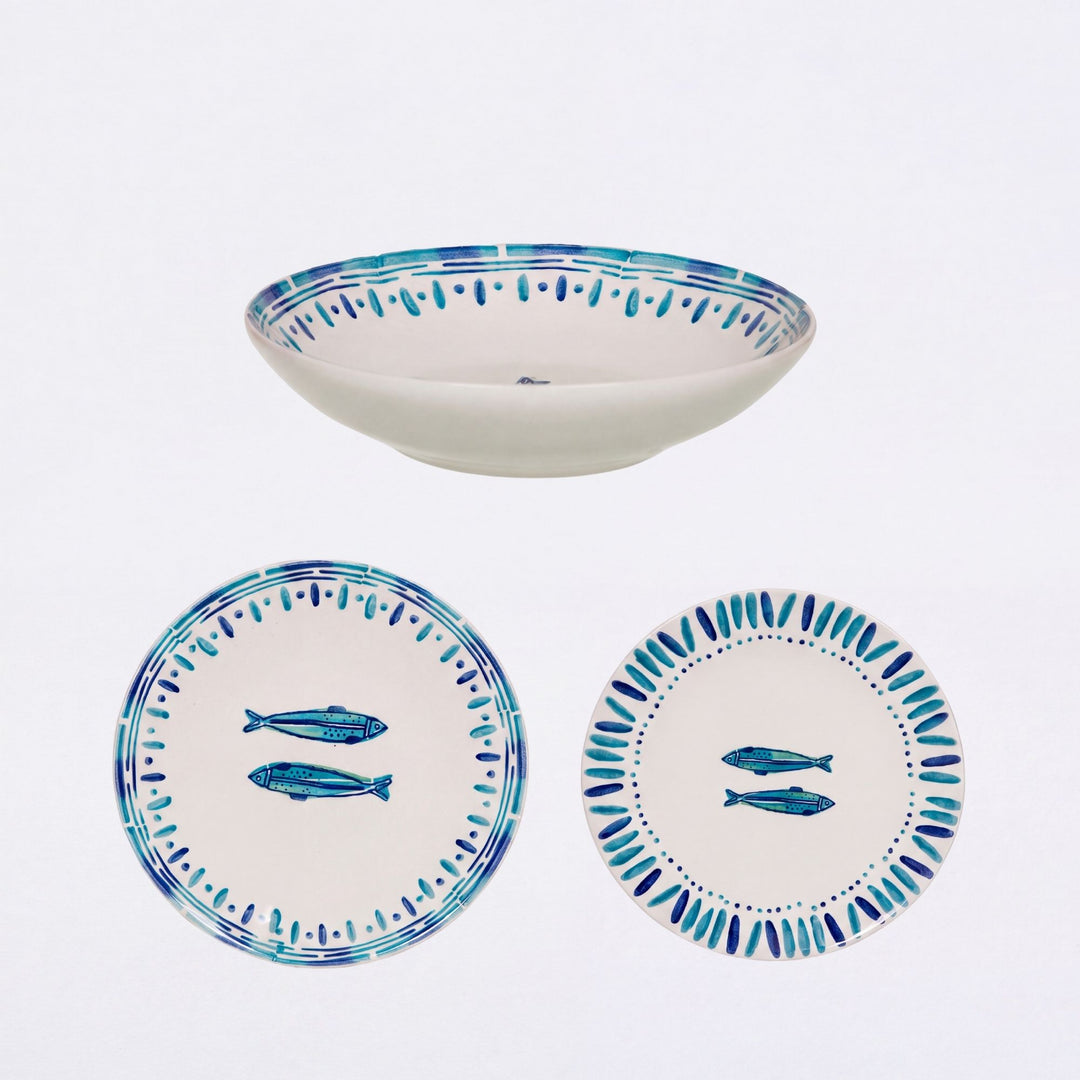 Kyanos ceramic tableware set with blue fish motifs, including plates and a serving bowl