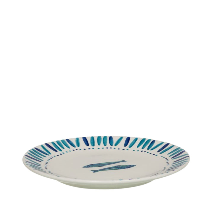 Side view of a Kyanos ceramic plate showing its shallow form and painted rim detail