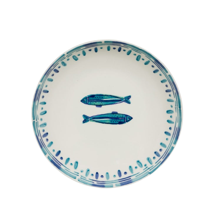 Top view of a Kyanos ceramic plate with blue fish motifs and a fine decorative border