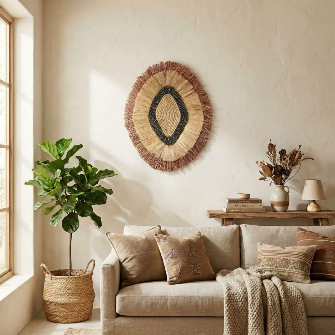 Cozy living room with a beige sofa, decorative pillows, and a woven Laras wall hanging.