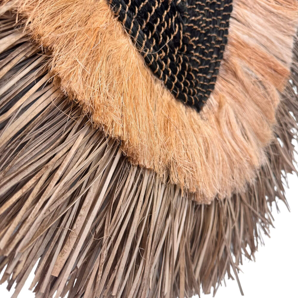 Close-up of the Laras Wall Deco showing layered natural fiber texture.