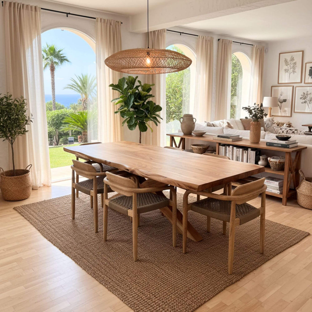 Dining area with Lea dining table and chairs in a bright room with large windows.