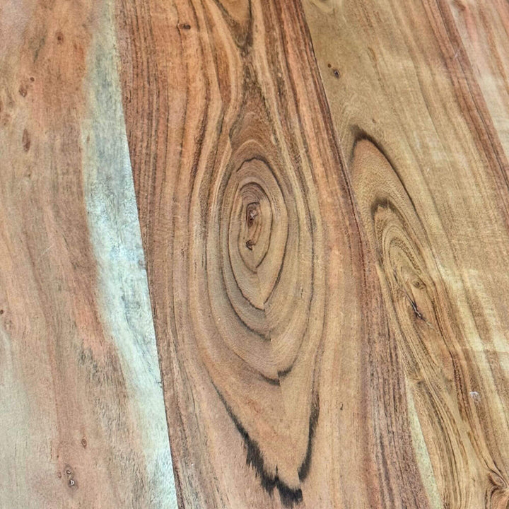 Close-up of a Lea dining table's wooden surface with visible grain and texture