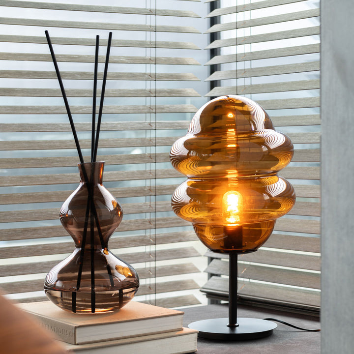 Lifestyle setting showing the Lily Land diffuser placed beside décor near a window.