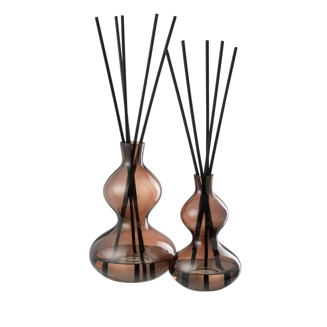 Front view of the Lily Land Fragrance Diffuser in amber glass with black reeds.