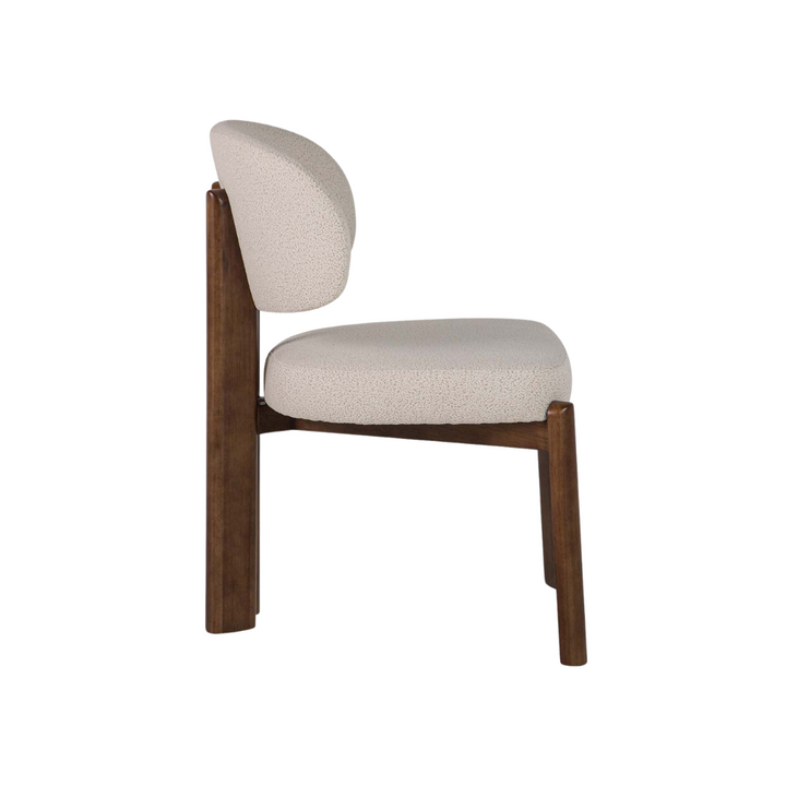 Side view of Lina dining chair showing oak frame and cream upholstery