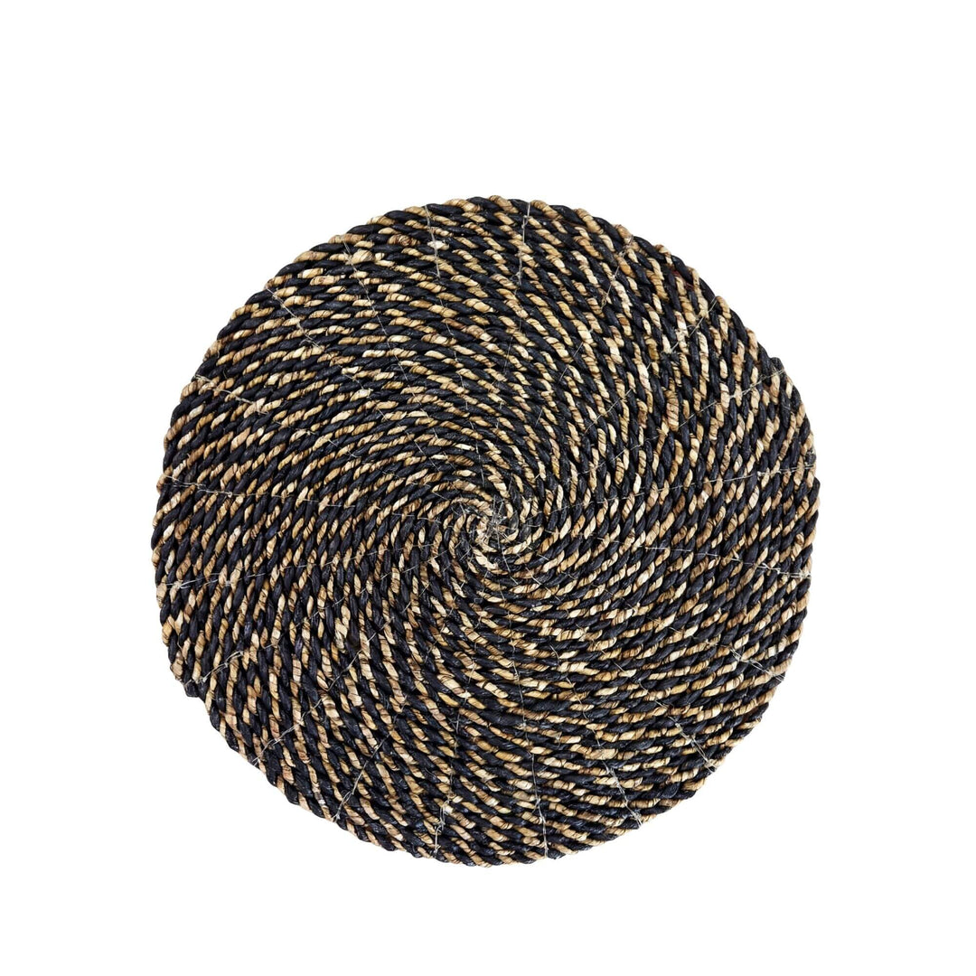 Top view of the Lombok palm leaf mat showing its circular braided pattern.