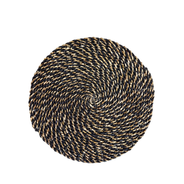Top view of the Lombok palm leaf mat showing its circular braided pattern.