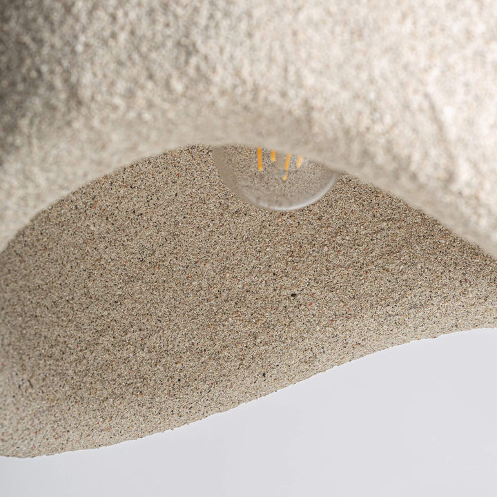 Interior detail of the Lua ceiling lamp showing the curved resin shade and bulb opening