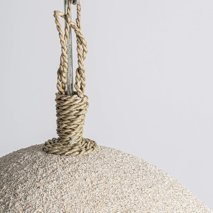 1. Close-up of the Lua ceiling lamp suspension detail with wrapped natural cord and textured resin shade