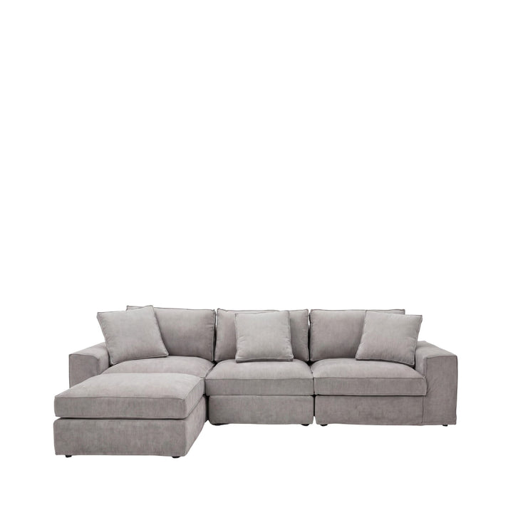 Front view of the sofa and pouf highlighting the generous seating and coordinated design.