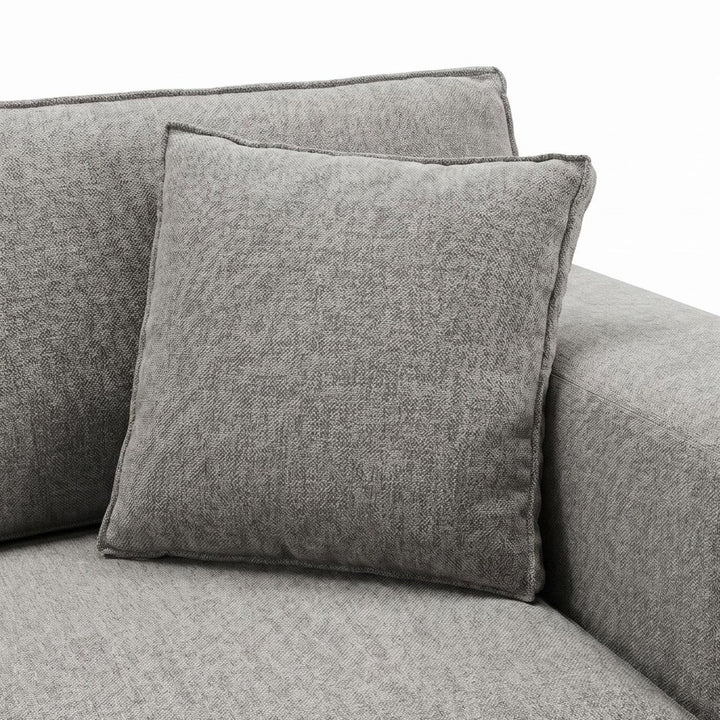 Close-up detail of the cushion and fabric upholstery showing the soft woven texture.