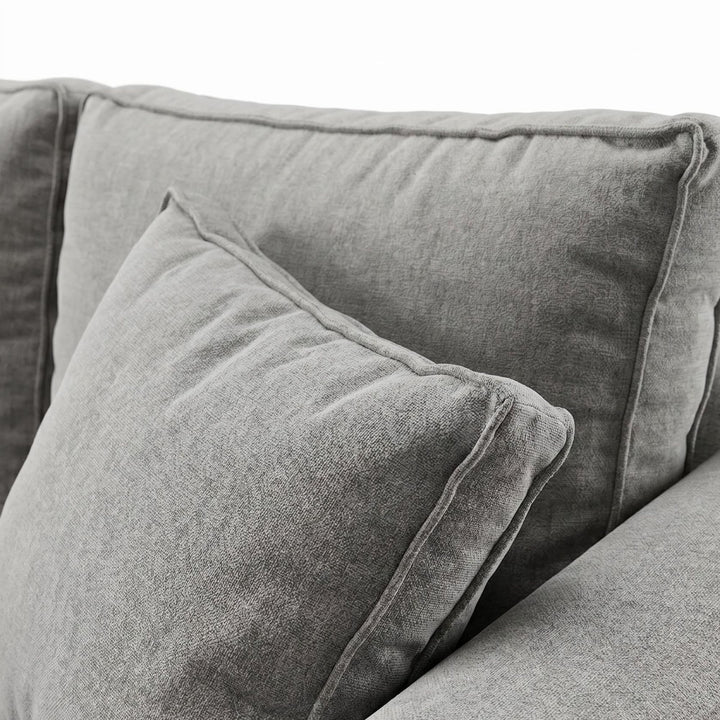 Close-up detail of the cushion and fabric upholstery showing the soft woven texture.