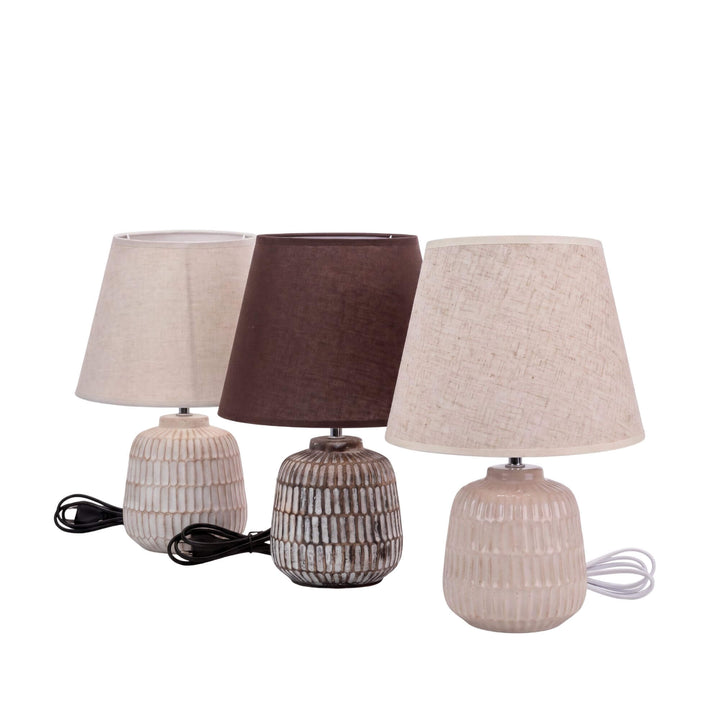 Front view of the Luma table lamps showing the different ceramic finishes and textile shades.