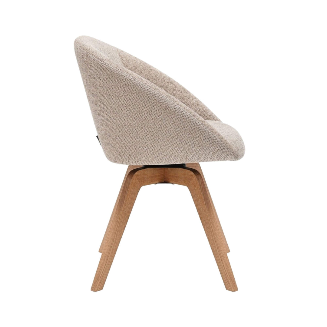 Side view highlighting the ergonomic shape and swivel base of the Lume dining chair.