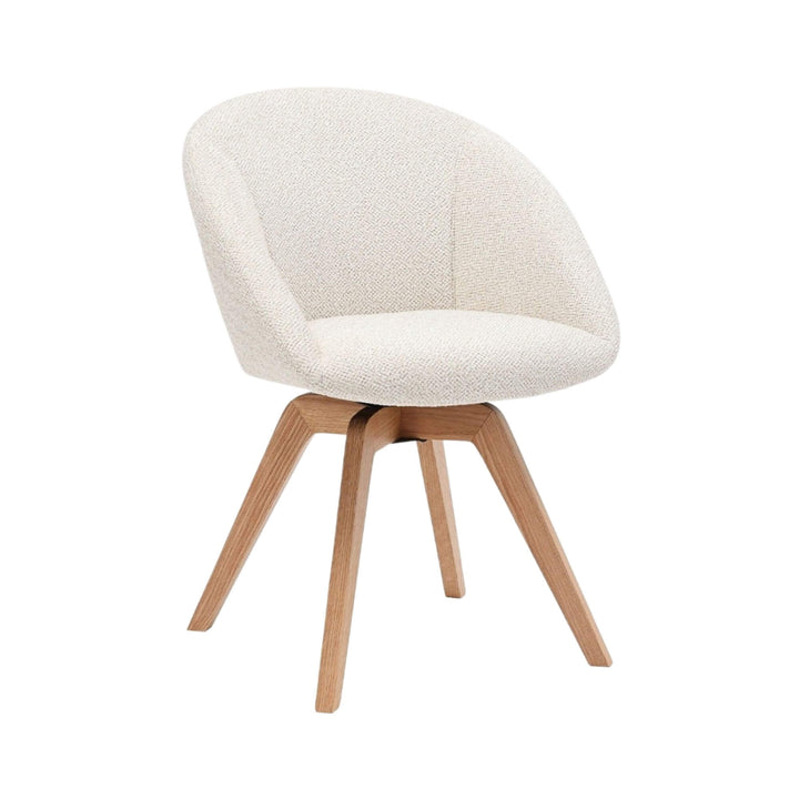 Angled view of the Lume dining chair showing its curved upholstered seat and ash wood legs.