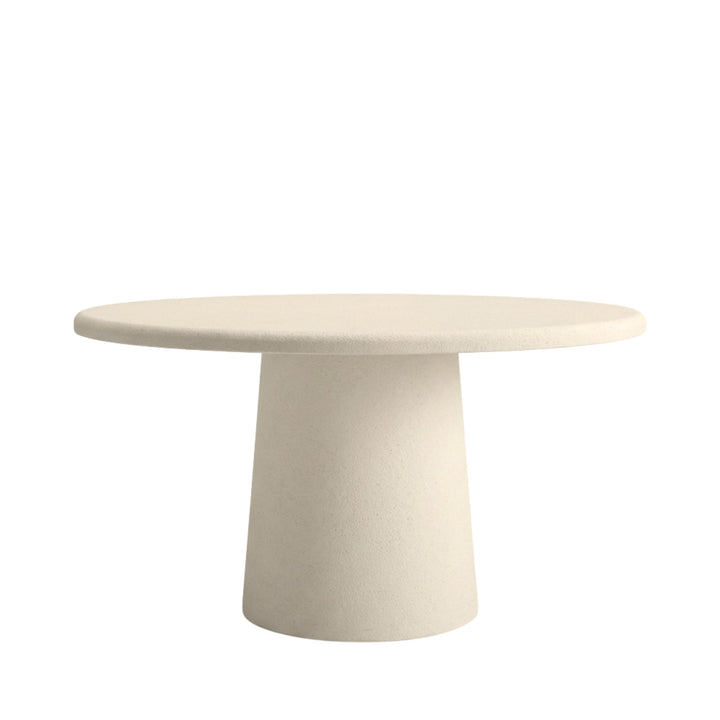 Front view of Luna microcement round dining table showing its smooth circular top and solid pedestal base.