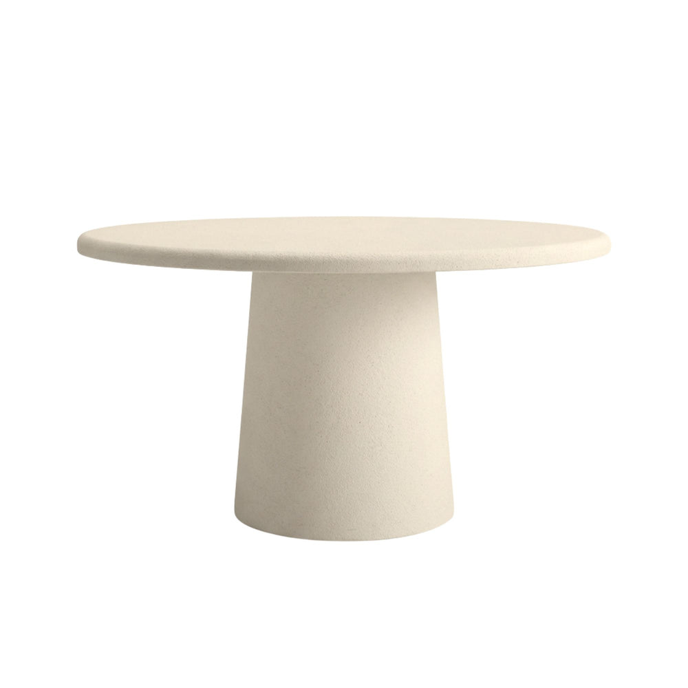 Front view of Luna microcement round dining table showing its smooth circular top and solid pedestal base.