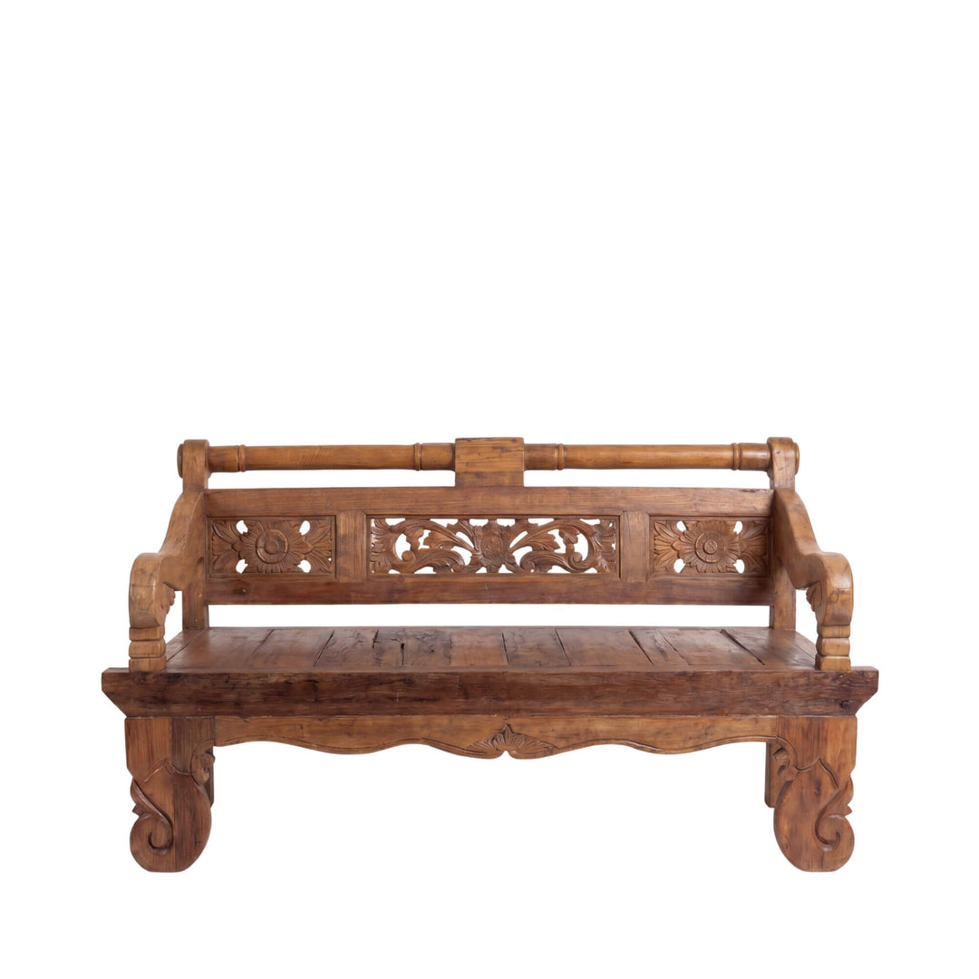 Front view of the daybed highlighting its decorative carved apron and handcrafted teak wood structure.