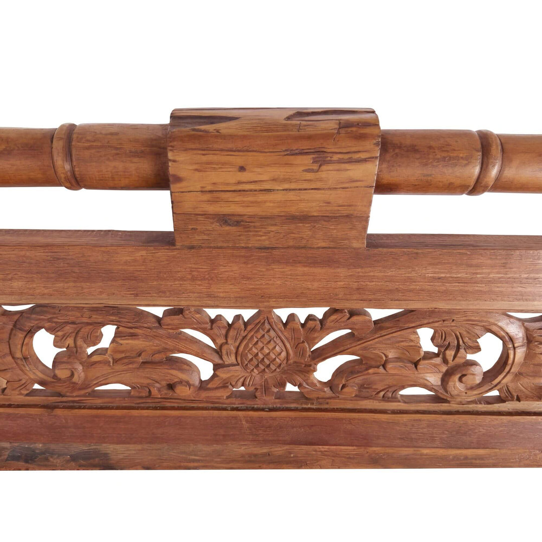 Close-up detail of the carved backrest panel showing the intricate teak wood craftsmanship.