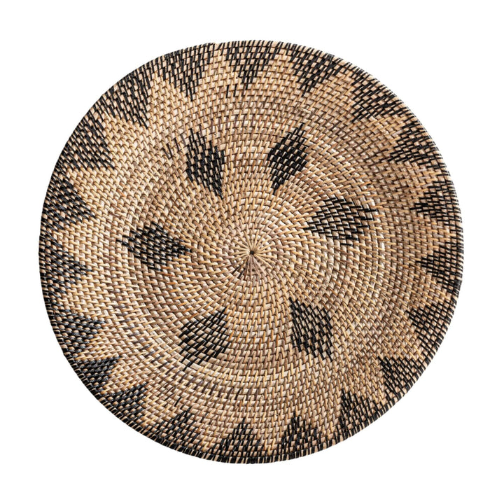 Handwoven rattan decorative plate in natural and black geometric pattern from the Lyra Collection.