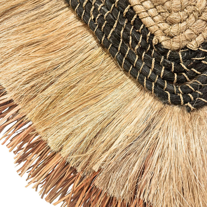 Close-up of Laras Wall Deco made of abaca and cotton with natural oval design and earthy tones