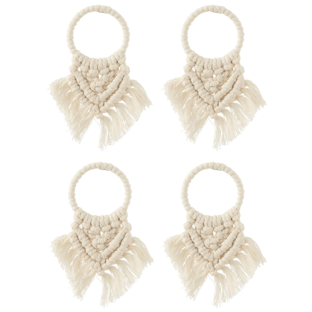 Set of four handmade macramé napkin rings in natural cotton with fringe detail for table decor.