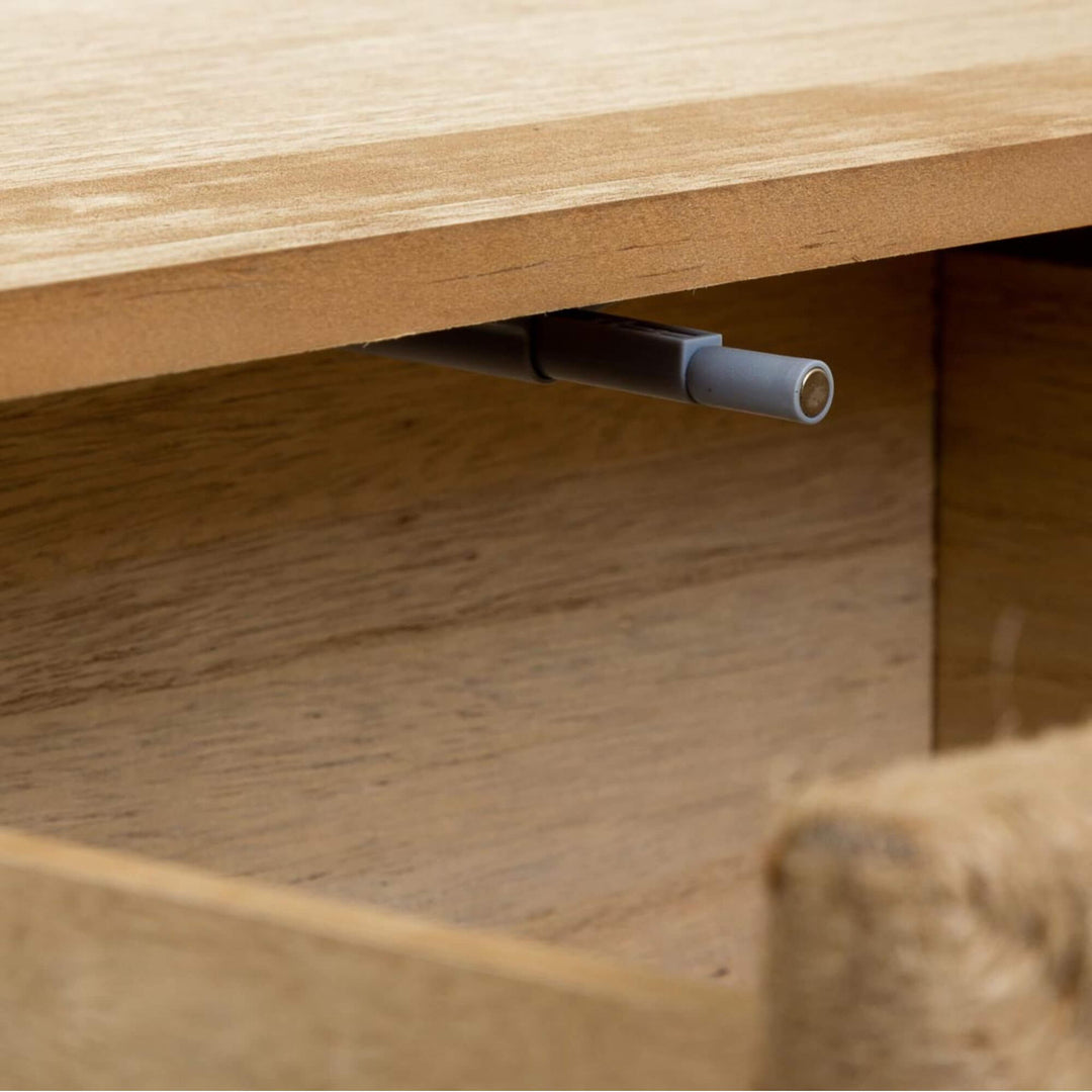 Detail view inside the Madura bedside table showing the drawer mechanism and wooden construction