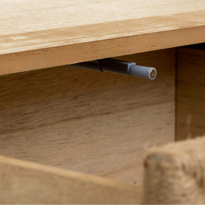 Detail view inside the Madura bedside table showing the drawer mechanism and wooden construction