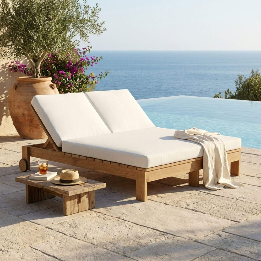 Outdoor poolside setting featuring the Maldives double sunbed with white cushions and teak structure.