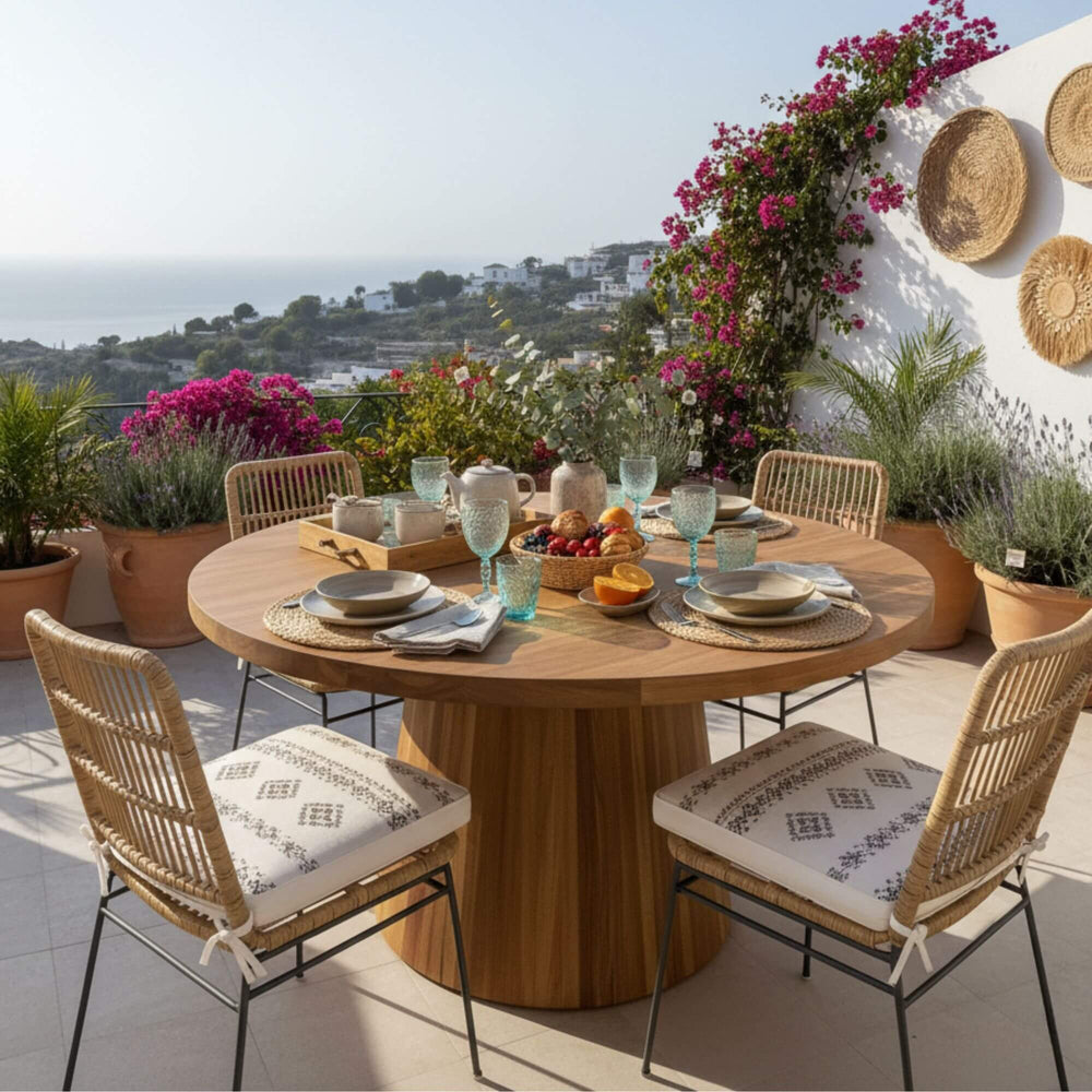 Outdoor dining setup featuring the Maldives round recycled teak table with conical base.
