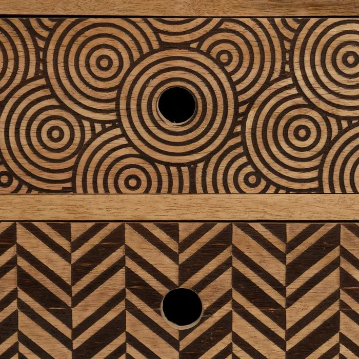 Close-up of the carved geometric detail on the Maluku bedside table drawer.