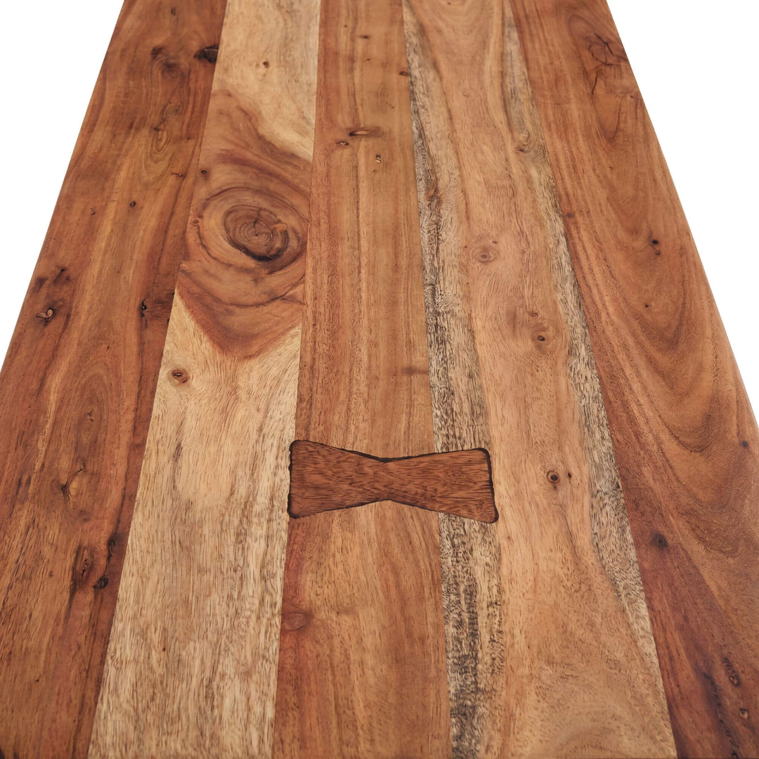 Close-up detail of the tabletop showing the rich mango wood grain and butterfly joint detail.