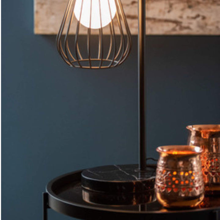 Marma table lamp lit, adding warm light to a modern interior.