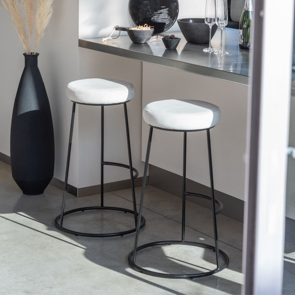 Styled interior view showing the tall black vase as a floor decorative accent.