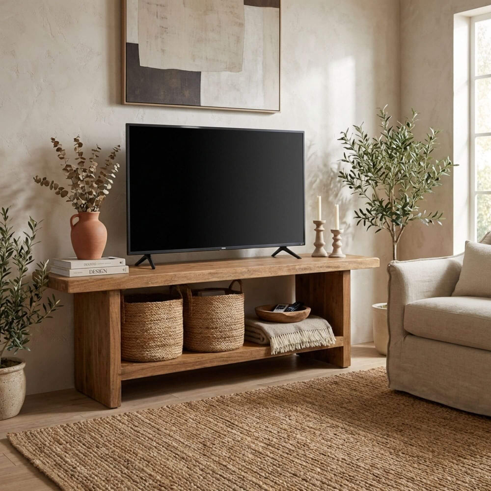 Styled living room setting featuring the Matras TV console supporting a television with decorative baskets below.