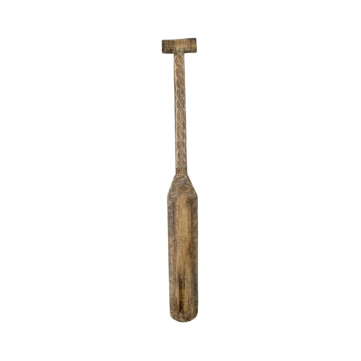 Front view of the Maui paddle showing its natural weathered finish and carved detailing.