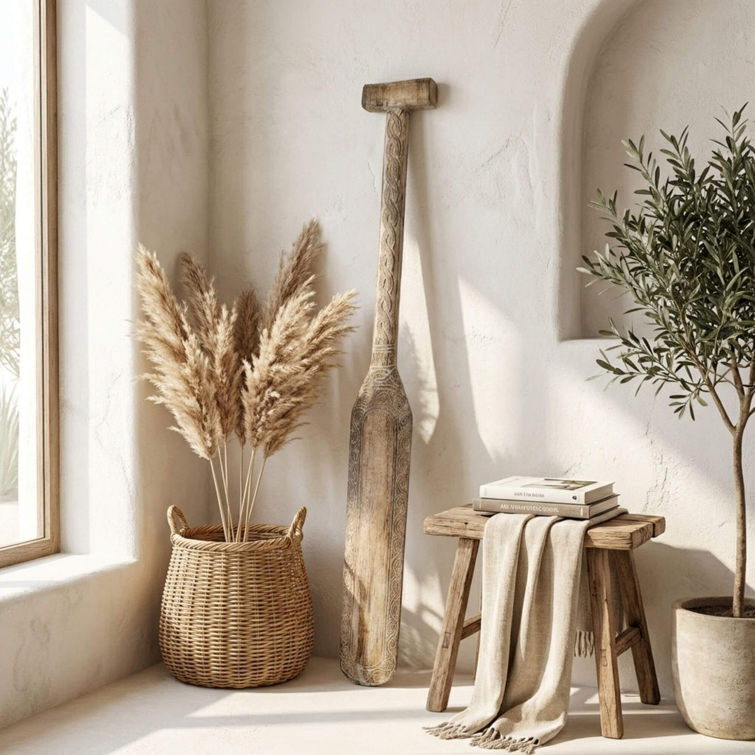 Styled interior setting featuring the Maui paddle displayed vertically near a bench with woven decor.