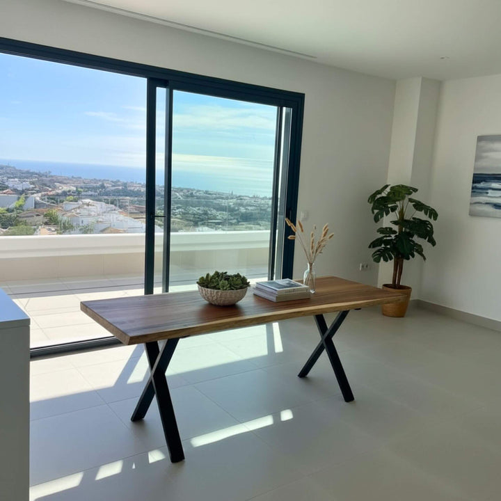 Suar wood dining table styled in a modern interior with ocean views.