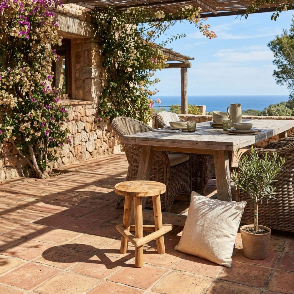 Outdoor setting featuring the Maupiti stool placed on a rustic terrace.