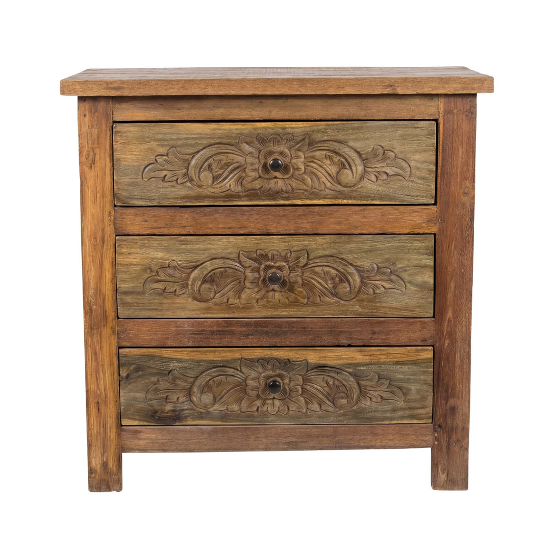Front view of the Medea carved teak wood drawer cabinet showing its three floral carved drawers.