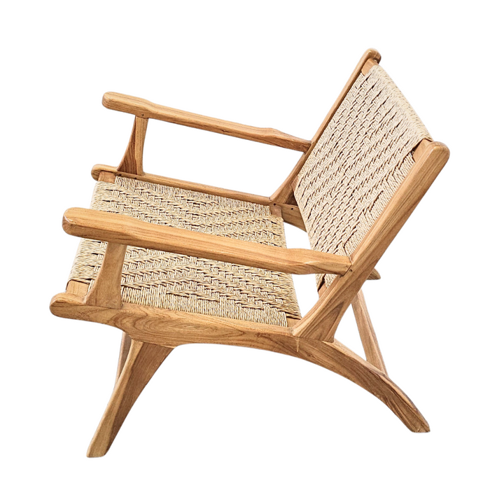 Side view of Milaidhoo teak wood lounge armchair highlighting its low profile and armrests.