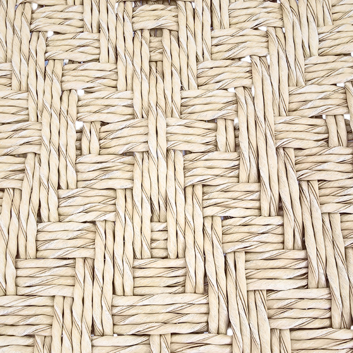Close-up detail of the synthetic rattan weave on the Milaidhoo lounge armchair seat.