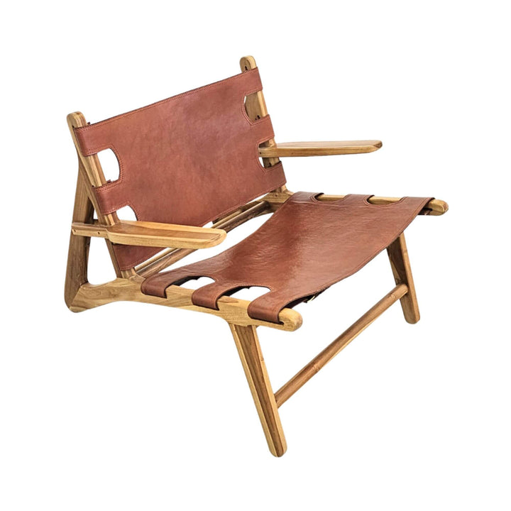 Front view of Milaidhoo leather lounge armchair showcasing its teak wood frame and suspended leather seat.