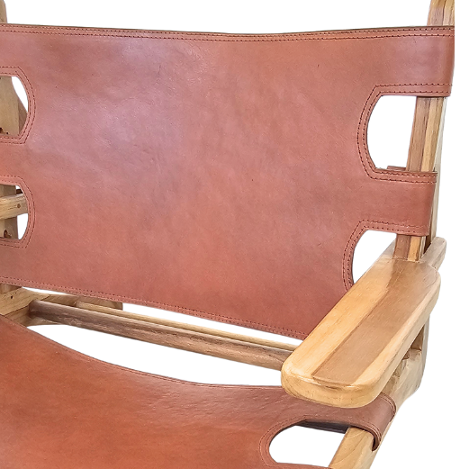 Close-up detail of leather seat and teak wood joints on the Milaidhoo armchair.