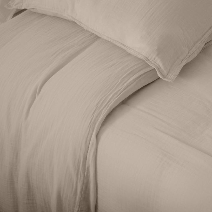 Detail of the Milos duvet cover showing its lightweight muslin weave and relaxed finish.