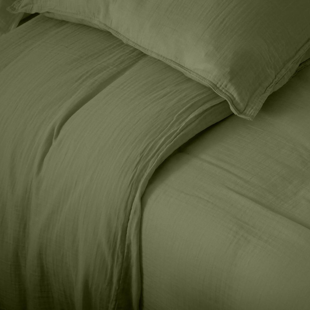 Detail of the Milos duvet cover showing its lightweight muslin weave and relaxed finish.
