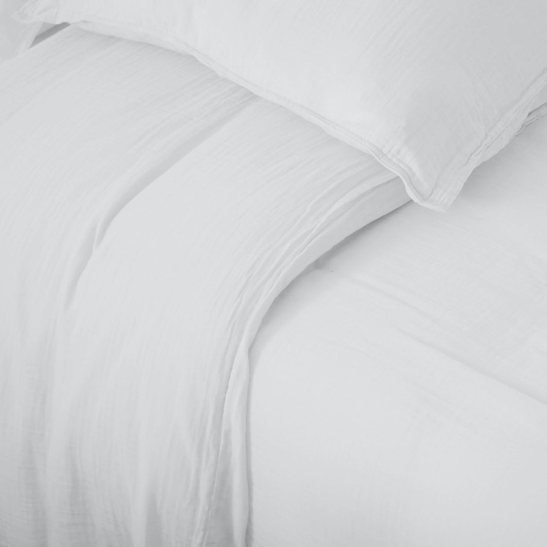 Detail of the Milos duvet cover showing its lightweight muslin weave and relaxed finish.