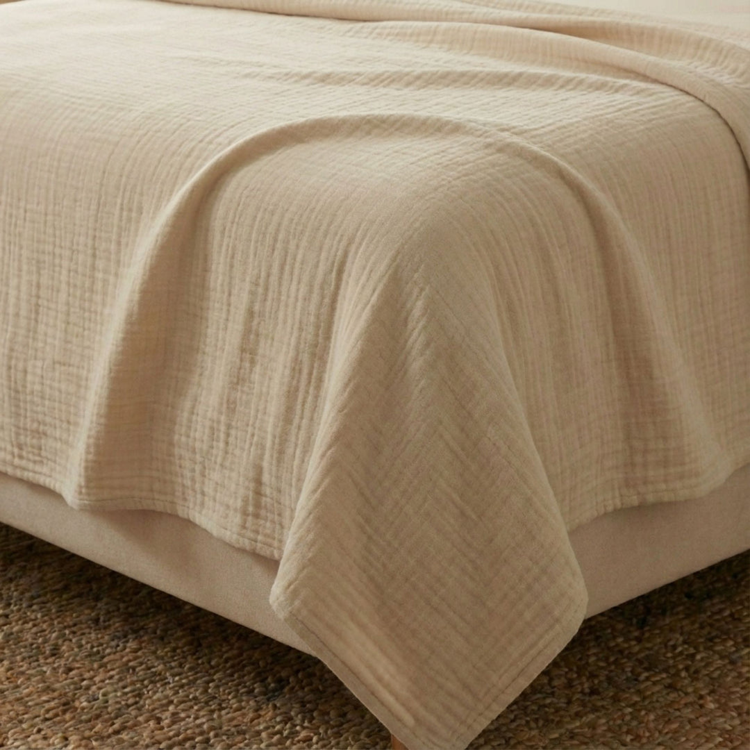 Close-up view of the Milos top sheet highlighting its muslin cotton texture and soft natural finish.